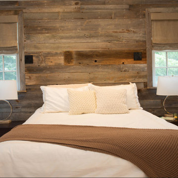 Bedroom with wood-paneled wall