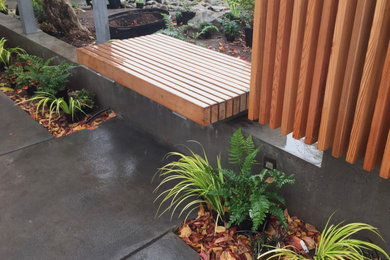 Photo of a small modern drought-tolerant, rock and partial sun courtyard river rock landscaping in Seattle for winter.