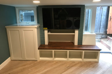 Small arts and crafts walk-out porcelain tile and beige floor basement game room photo in San Francisco with green walls
