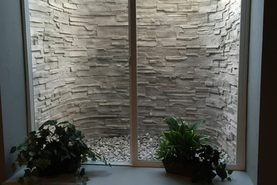 Basement - mid-sized traditional carpeted basement idea in Denver with beige walls, a standard fireplace and a stone fireplace