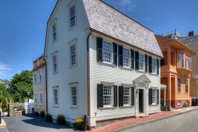 Elegant white three-story wood and clapboard house exterior photo in Providence with a gambrel roof, a shingle roof and a brown roof
