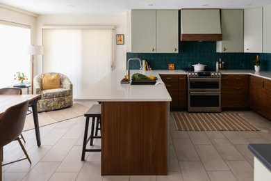 Large 1950s u-shaped porcelain tile and beige floor eat-in kitchen photo in Phoenix with a single-bowl sink, flat-panel cabinets, quartz countertops, blue backsplash, ceramic backsplash, stainless steel appliances and a peninsula