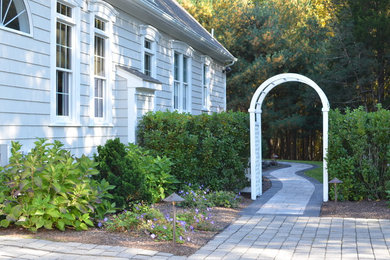 Inspiration for a large traditional partial sun side yard concrete paver landscaping in Providence for summer.