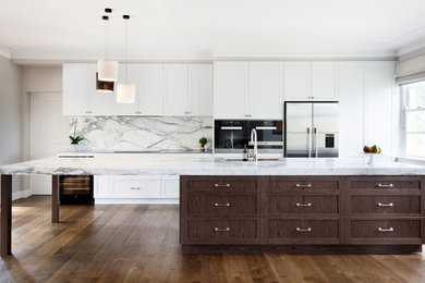 Design ideas for an expansive transitional galley open plan kitchen in Sydney with an undermount sink, shaker cabinets, medium wood cabinets, marble benchtops, multi-coloured splashback, marble splashback, stainless steel appliances, medium hardwood floors, with island, brown floor and multi-coloured benchtop.