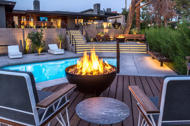 Design ideas for an expansive transitional backyard patio in Phoenix with a fire feature, concrete slab and no cover.