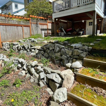 Before: tiered patio, retaining walls, stairs