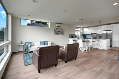 Mid-sized trendy open concept medium tone wood floor and brown floor family room photo in Orange County with white walls, no fireplace and no tv