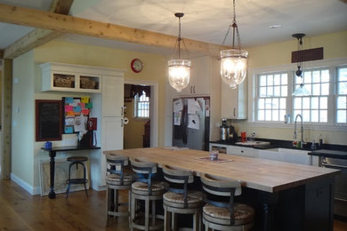Huge urban l-shaped medium tone wood floor and brown floor eat-in kitchen photo in Bridgeport with an undermount sink, shaker cabinets, white cabinets, solid surface countertops, red backsplash, brick backsplash, stainless steel appliances and an island