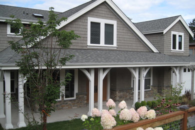 Design ideas for a mid-sized arts and crafts two-storey brown exterior in Seattle with mixed siding and a gable roof.
