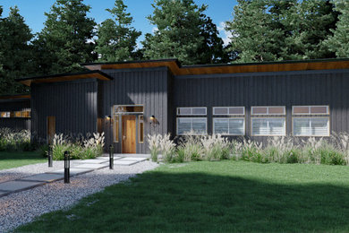 Example of a mid-sized trendy black one-story wood and board and batten house exterior design in Seattle with a shed roof, a metal roof and a black roof