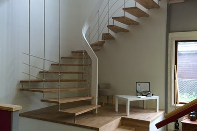 This is an example of a large modern wood u-shaped staircase in Clermont-Ferrand.
