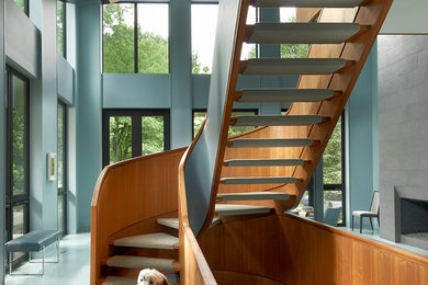 Inspiration for a transitional curved open and wood railing staircase remodel in Chicago