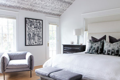 Inspiration for a transitional bedroom in Philadelphia with white walls, medium hardwood floors and brown floor.