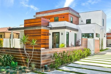 Mid-sized trendy white two-story mixed siding exterior home photo in Orange County with a metal roof