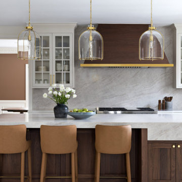 Custom Walnut and White Kitchen Remodel with Marble Slab Backsplash and Brass Ac