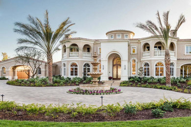 Huge tuscan beige two-story mixed siding house exterior photo in Orange County