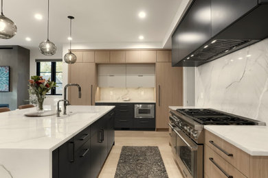 Example of a large minimalist l-shaped coffered ceiling open concept kitchen design in Denver with an undermount sink, flat-panel cabinets, light wood cabinets, paneled appliances and an island