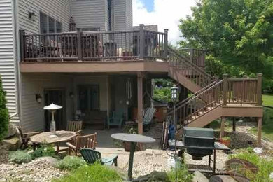 Example of a large arts and crafts backyard deck design in Other with no cover