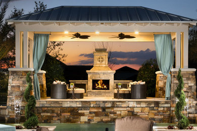 Inspiration for a large transitional backyard patio in Orlando with a fire feature, concrete pavers and a gazebo/cabana.