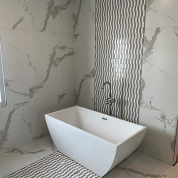 Mixed Material Floor To Ceiling Tile In Master Bathroom With Freestanding Tub