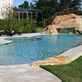 Mittelgroßer Maritimer Pool hinter dem Haus in runder Form mit Wasserrutsche und Pflasterklinker in Orlando