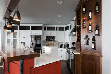 Inspiration for a large industrial l-shaped open plan kitchen in Seattle with a farmhouse sink, shaker cabinets, white cabinets, quartz benchtops, multi-coloured splashback, cement tile splashback, stainless steel appliances, dark hardwood floors, with island, brown floor and multi-coloured benchtop.