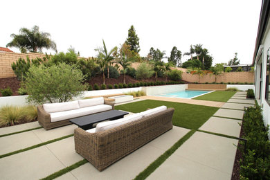 Minimalist backyard rectangular pool photo in San Diego with decking