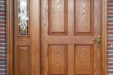 Example of a mid-sized classic entryway design in Denver with a dark wood front door