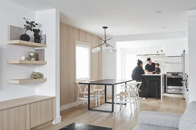 Example of a danish medium tone wood floor kitchen/dining room combo design in Toronto
