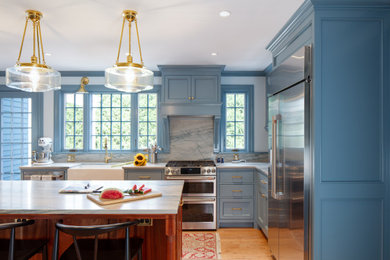 Kitchen - traditional medium tone wood floor kitchen idea in Boston with a farmhouse sink, recessed-panel cabinets, blue cabinets, quartzite countertops, blue backsplash, stone slab backsplash, stainless steel appliances, an island and blue countertops