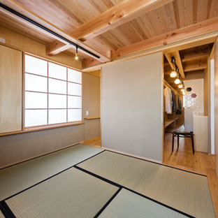 Asian bedroom in Other with beige walls and tatami floors.