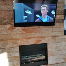 Reclaimed lumber fireplace with flatscreen televison