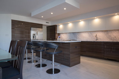 Inspiration for a large contemporary l-shaped marble floor eat-in kitchen remodel in Miami with an undermount sink, flat-panel cabinets, marble countertops, gray backsplash, stone slab backsplash, stainless steel appliances and an island
