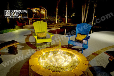 Example of a beach style courtyard patio design in Other with a fire pit