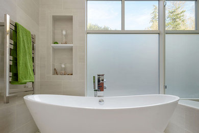 Large contemporary bathroom in Seattle with furniture-like cabinets, dark wood cabinets, a freestanding tub, a double shower, a one-piece toilet, gray tile, porcelain tile, white walls, pebble tile floors, a vessel sink and quartzite benchtops.