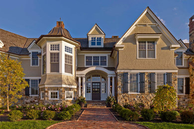 Photo of an expansive traditional three-storey brown house exterior in Philadelphia with a gable roof, mixed siding and a mixed roof.