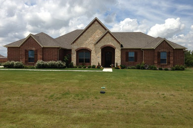 Mid-sized traditional beige one-story brick gable roof idea in Dallas