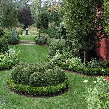 Formal plantings dotted with fragrant and colorful perennials and annuals