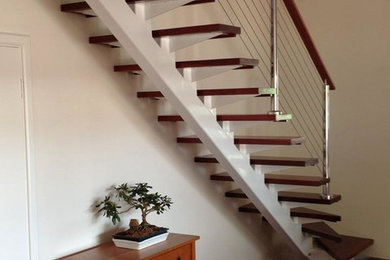 All custom made staircases, this is a steel staircase with timber treads & stain