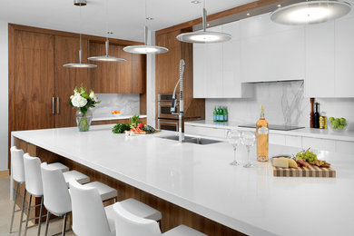 Kitchen - large contemporary galley light wood floor kitchen idea in Toronto with flat-panel cabinets, dark wood cabinets, quartz countertops, marble backsplash, stainless steel appliances and an island