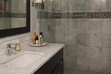 Inspiration for a mid-sized contemporary master white tile and ceramic tile marble floor walk-in shower remodel in Detroit with flat-panel cabinets, black cabinets, a one-piece toilet, gray walls, an undermount sink and quartzite countertops