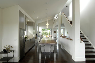 Photo of a contemporary open plan dining in Sydney with white walls, dark hardwood floors and no fireplace.