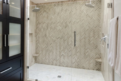 Example of a large transitional master marble floor and gray floor alcove shower design in Richmond with shaker cabinets, dark wood cabinets, beige walls, an undermount sink, marble countertops and a hinged shower door