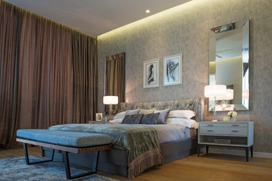 This is an example of a large contemporary bedroom in Surrey.