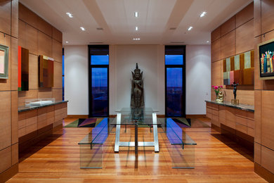 Example of a trendy medium tone wood floor enclosed dining room design in Oklahoma City with brown walls and no fireplace