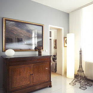 Inspiration for a mid-sized eclectic entryway in Paris with grey walls and painted wood floors.
