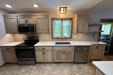 Example of a mid-sized transitional eat-in kitchen design in Other with shaker cabinets, light wood cabinets and quartz countertops