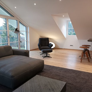 Example of a mid-sized trendy open concept light wood floor home theater design in Munich with white walls