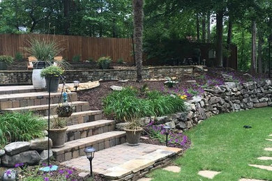 Design ideas for a large rustic full sun backyard brick retaining wall landscape in Atlanta.
