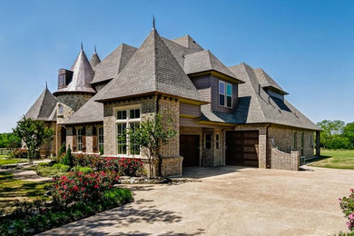 Large traditional brown two-story mixed siding house exterior idea in Dallas
